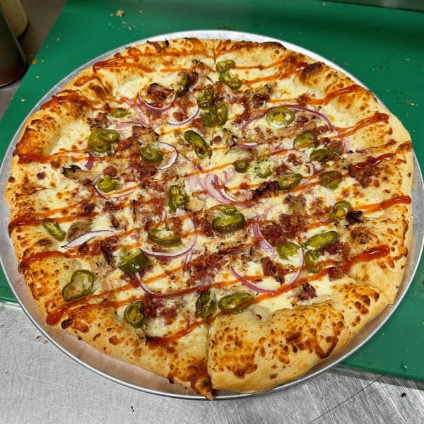 Clarksburg Pizza Co's pizza with bacon, red onions, jalapenos, and a BBQ sauce drizzle.
